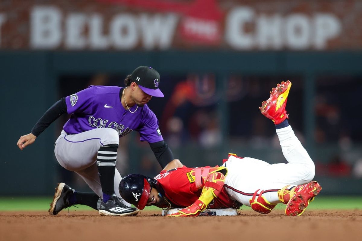 Aug 28, 2026; Atlanta, Georgia, USA; Atlanta Braves right fielder Ronald Acuna Jr. (13) slides safely into second with a double as Colorado Rockies shortstop Ezequiel Tovar (14) attempts a tag in the fifth inning at Truist Park. Mandatory Credit: Brett Davis-Imagn Images