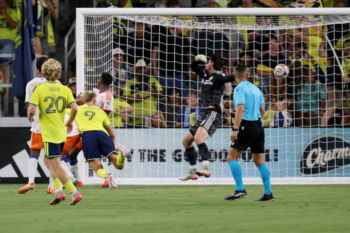 Aug 29, 2026; Nashville, Tennessee, USA;  Nashville SC forward Sam Surridge (9) heads the ball past FC Cincinnati goalkeeper Roman Celentano (18) and scores during the first half at Geodis Park.  Mandatory Credit: Alan Poizner-Imagn Images