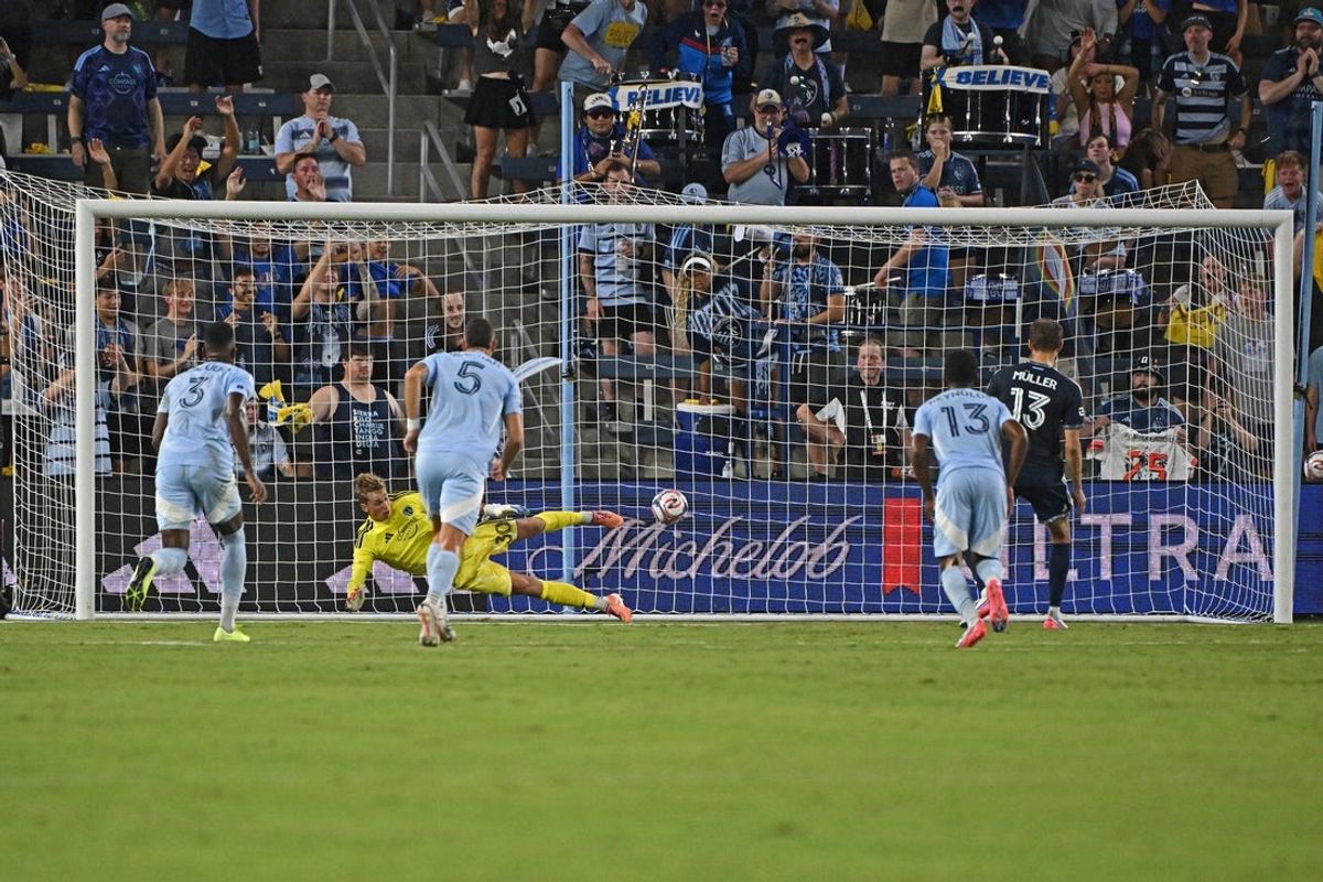 Aug 29, 2026; Kansas City, Kansas, USA;  Vancouver Whitecaps FC midfielder Thomas Muller (13) scores a goal on a penalty kick against Sporting Kansas City goalkeeper Stefan Cleveland (30) in the first half at Sporting Park.  Mandatory Credit: Peter Aiken-Imagn Images