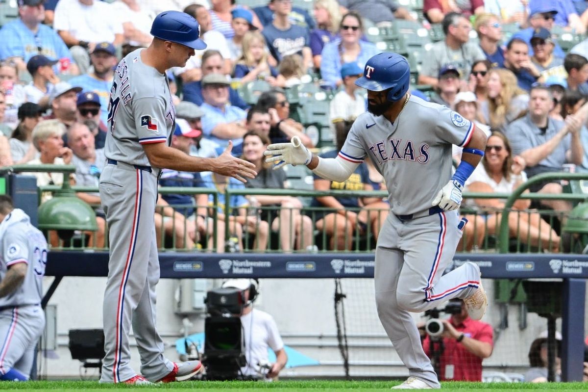 Aug 30, 2026; Milwaukee, Wisconsin, USA;  Texas Rangers center fielder Ezequiel Duran (20) is greeted by third base coach Corey Ragsdale after hitting a solo home run in the third inning against the Milwaukee Brewers at American Family Field.  Mandatory Credit: Benny Sieu-Imagn Images