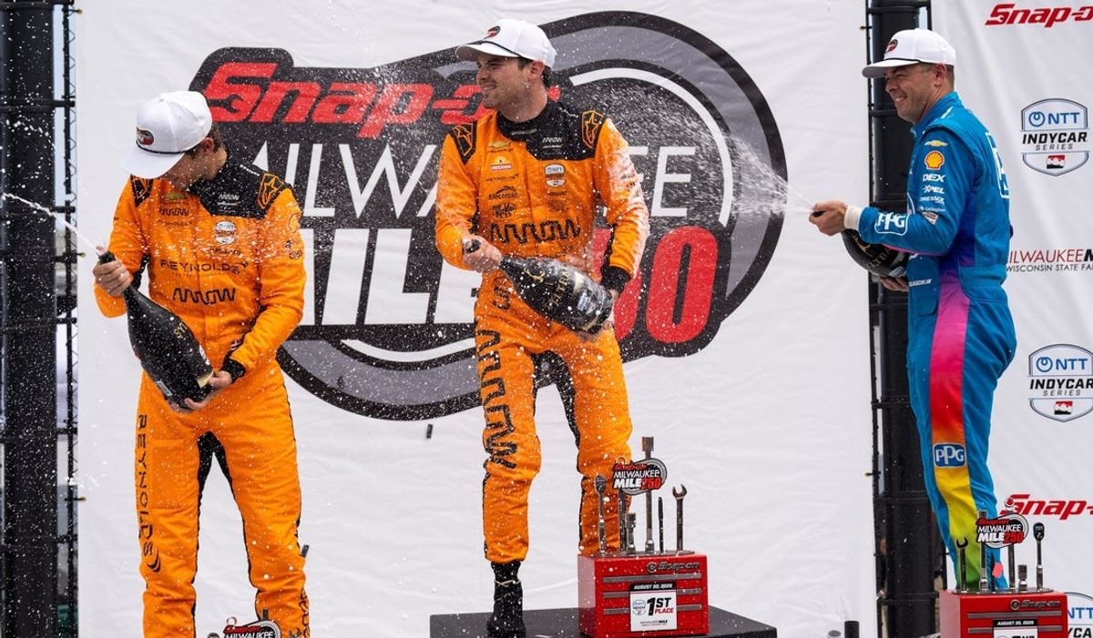 Race winner Pato O'Ward takes the top step on the podium after the Snap-on Milwaukee Mile 250 Sunday, Aug. 30, 2026 at the Milwaukee Mile in West Allis, Wisconsin. Scott McLaughlin, right, placed second, Christian Lundgaard placed third.