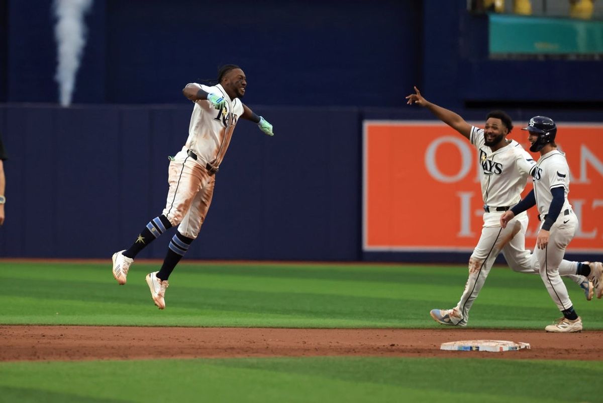 Aug 30, 2026; St. Petersburg, Florida, USA;  Tampa Bay Rays second base Jorge Mateo (9) is congratulated by  third baseman Junior Caminero (13) and  center fielder Jonny DeLuca (21) and teammates after  he hit the game winning RBI to  beat the  San Diego Padres  at Tropicana Field.  Mandatory Credit: Kim Klement Neitzel-Imagn Images