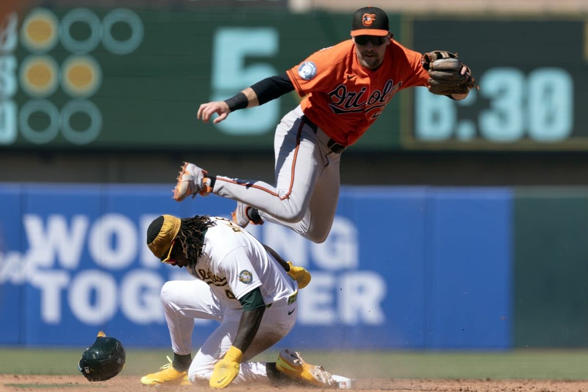 Aug 30, 2026; West Sacramento, California, USA;  Baltimore Orioles shortstop Gunnar Henderson (2) throws over Athletics right fielder Lawrence Butler (4) to complete a double play during the fifth inning at Sutter Health Park. Donovan Walton was out at first base.  Mandatory Credit: D. Ross Cameron-Imagn Images