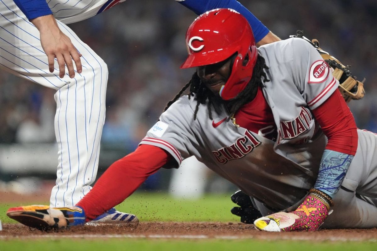 Aug 30, 2026; Chicago, Illinois, USA;  Cincinnati Reds shortstop Elly de la Cruz (44) dives back into first base against the Chicago Cubs during the fifth inning at Wrigley Field.  Mandatory Credit: David Banks-Imagn Images