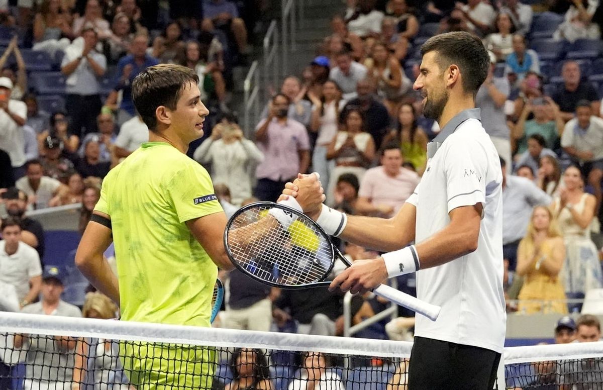 August 30, 2026; New York, United States;  Argentina's Mariano Navone shakes hands with Serbia's Novak Djokovic after winning his first round match.  Mandatory Credit: Robert Deutsch-Imagn Images