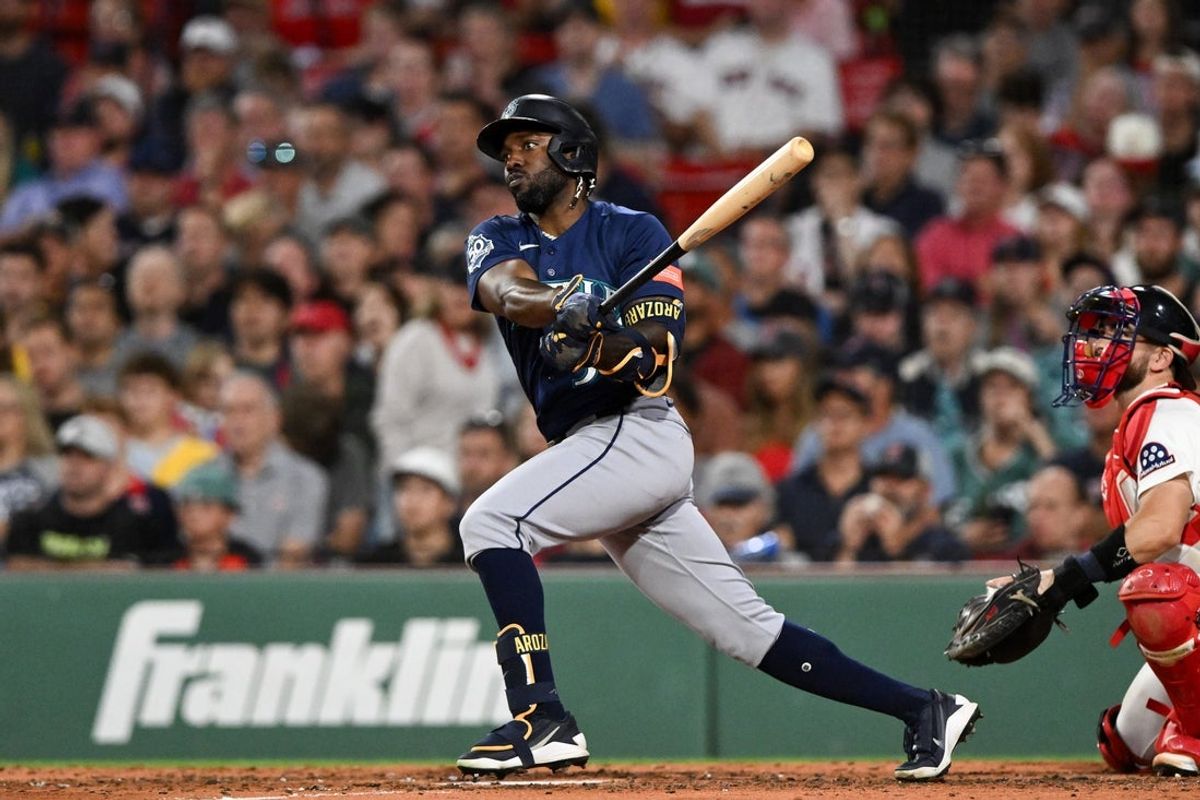 Aug 31, 2026; Boston, Massachusetts, USA; Seattle Mariners left fielder Randy Arozarena (56) hits a RBI single against the Boston Red Sox during the fifth inning at Fenway Park. Mandatory Credit: Brian Fluharty-Imagn Images