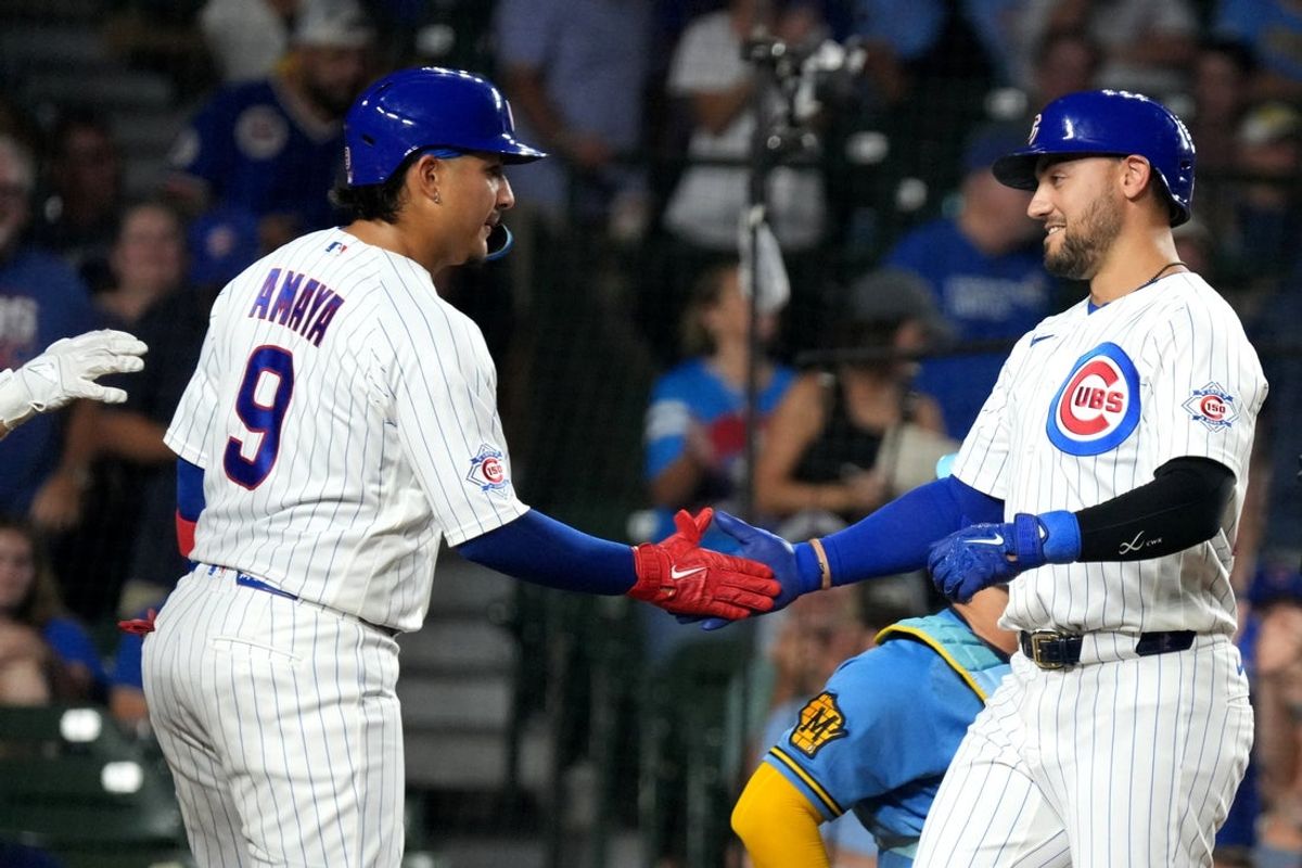 Aug 31, 2026; Chicago, Illinois, USA;  Chicago Cubs designated hitter Michael Conforto (20) is greeted by Chicago Cubs catcher Miguel Amaya (9) after hitting a two-run home run against the Milwaukee Brewers during the eighth inning at Wrigley Field.  Mandatory Credit: David Banks-Imagn Images