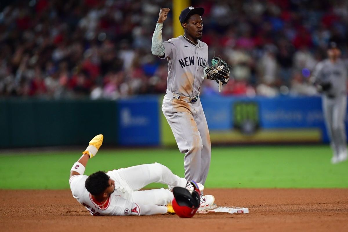 Sep 1, 2026; Anaheim, California, USA; Los Angeles Angels second baseman Oswald Peraza (2) is safe at second as New York Yankees second baseman Jazz Chisholm Jr. (13) reacts during the fifth inning at Angel Stadium. Mandatory Credit: Gary A. Vasquez-Imagn Images