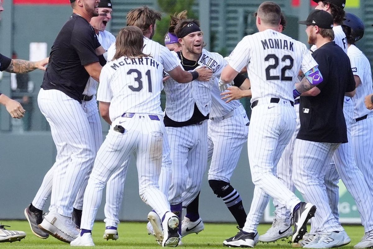 Sep. 2, 2026; Denver, Colorado, USA;  Colorado Rockies pinch hitter Brett Sullivan (26) (center) celebrates after hitting a two-run single in the eleventh inning against the Baltimore Orioles at Coors Field.  Mandatory Credit: Ron Chenoy-Imagn Images