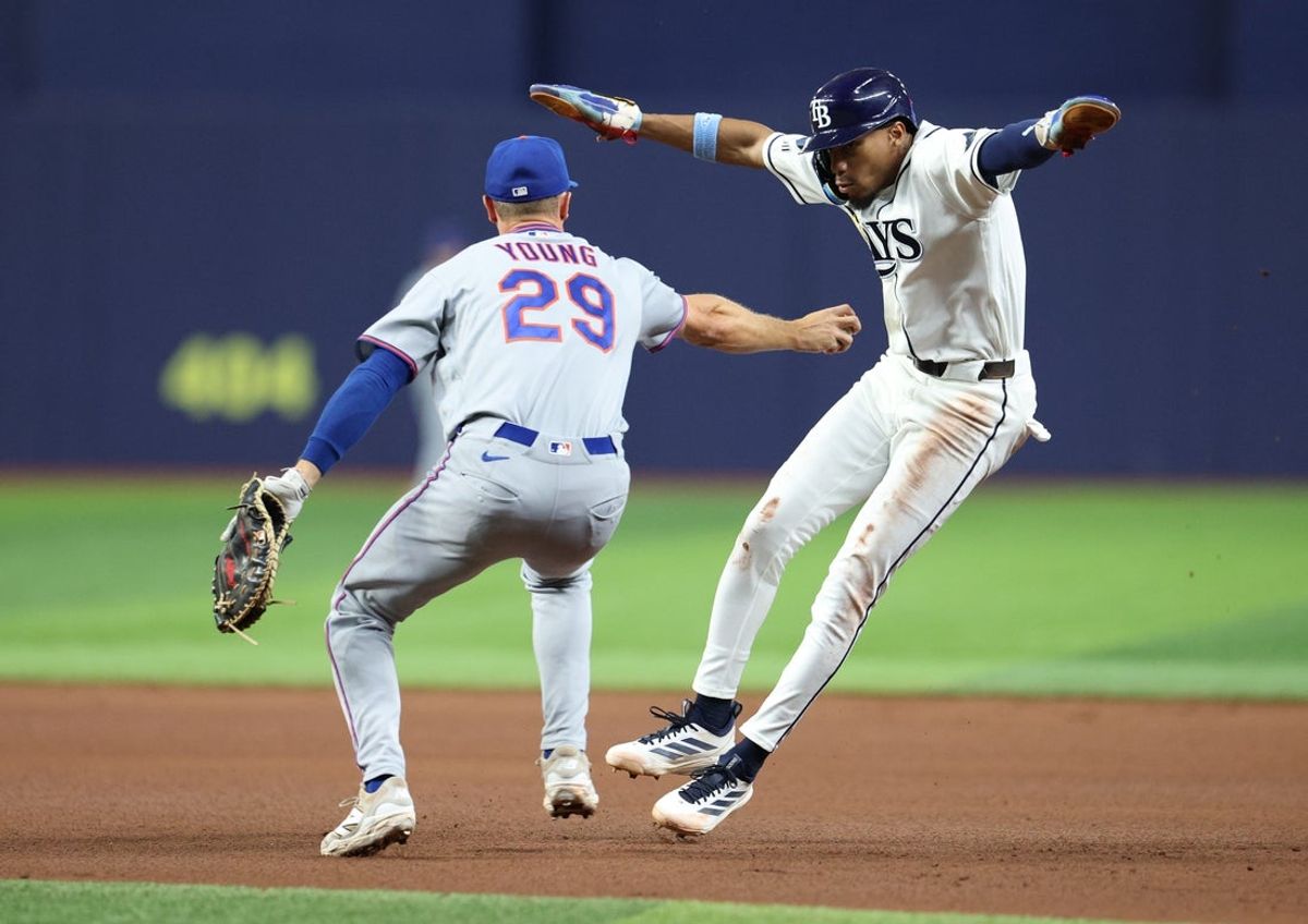 Sep 2, 2026; St. Petersburg, Florida, USA;  Tampa Bay Rays outfielder Chandler Simpson (14) avoids a tag by New York Mets first baseman Jared Young (29) during the fourth inning at Tropicana Field. at Tropicana Field.  Mandatory Credit: Nathan Ray Seebeck-Imagn Images