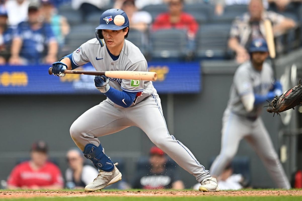 Sep 3, 2026; Cleveland, Ohio, USA; Toronto Blue Jays center fielder Brett Bateman (21) hits a bunt single during the fifth inning against the Cleveland Guardians at Progressive Field. Mandatory Credit: Ken Blaze-Imagn Images
