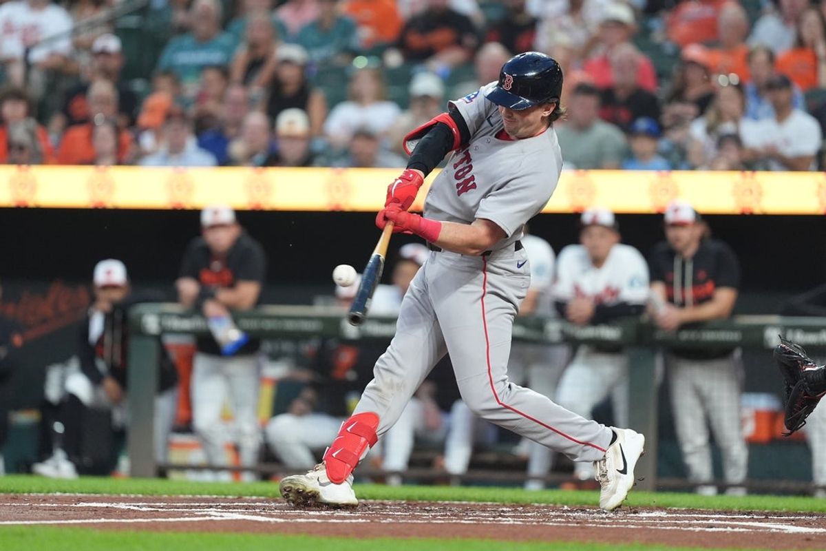 Sep 3, 2026; Baltimore, Maryland, USA;  Boston Red Sox catcher Adley Rutschman (31) hits a home run against the Baltimore Orioles during the first inning at Oriole Park at Camden Yards.  Mandatory Credit: Gregory Fisher-Imagn Images