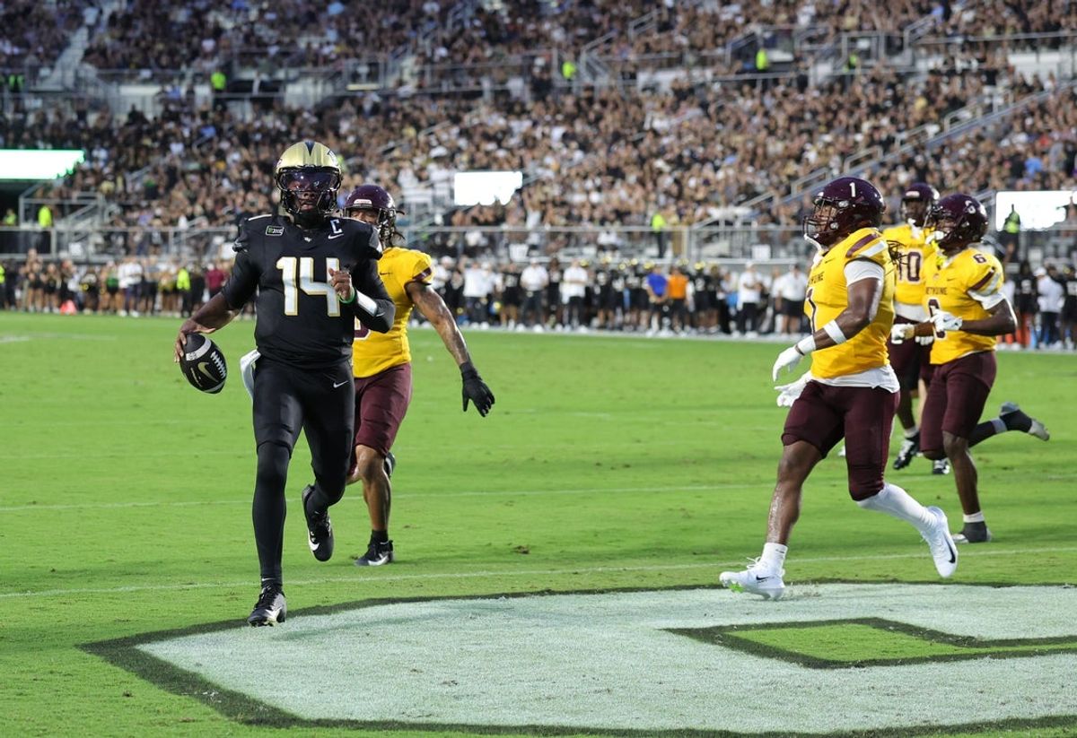 Sep 3, 2026; Orlando, Florida, USA;  Central Florida quarterback Alonza Barnett III (14) runs for a touchdown during the first quarter against Bethune-Cookman at Acrisure Bounce House.  Mandatory Credit: Mike Watters-Imagn Images