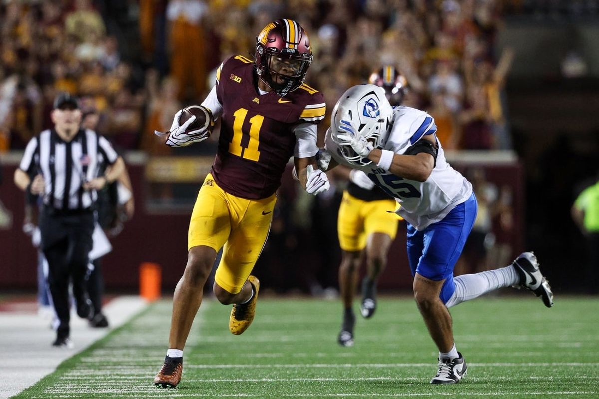 Sep 3, 2026; Minneapolis, Minnesota, USA; Minnesota Golden Gophers wide receiver Javon Tracy (11) runs after a catch as Eastern Illinois Panthers safety Brandon Worsley (15) defends during the first half at Huntington Bank Stadium. Mandatory Credit: Matt Krohn-Imagn Images