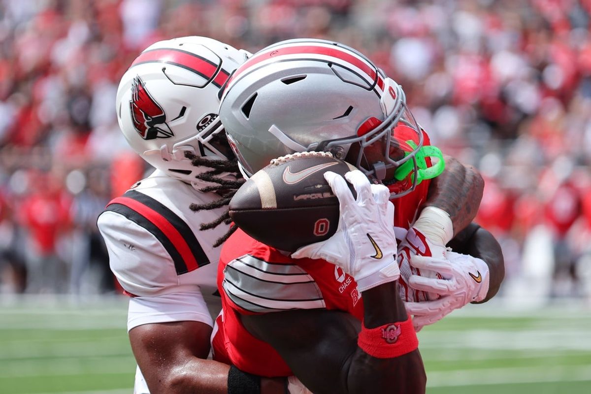 Sep 5, 2026; Columbus, Ohio, USA;  Ohio State Buckeyes wide receiver Jeremiah Smith (4) catches the touchdown as Ball State Cardinals defensive back Willizhuan Yates (4) defends during the first quarter at Ohio Stadium.  Mandatory Credit: Joseph Maiorana-Imagn Images