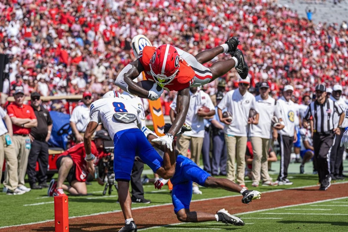 Sep 5, 2026; Athens, Georgia, USA; Georgia Bulldogs tight end Elyiss Williams (10) hurdles Tennessee State Tigers safety Brendan Hale (8) for a touchdown during the first quarter at Sanford Stadium. Mandatory Credit: Dale Zanine-Imagn Images