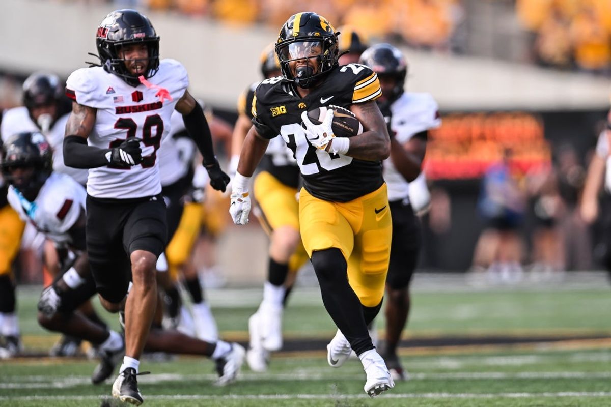 Sep 5, 2026; Iowa City, Iowa, USA;  Iowa Hawkeyes running back Kamari Moulton (28) runs for a 66 yard touchdown as Northern Illinois Huskies cornerback Romelo Walker (29) pursues during the first quarter at Kinnick Stadium.  Mandatory Credit: Jeffrey Becker-Imagn Images