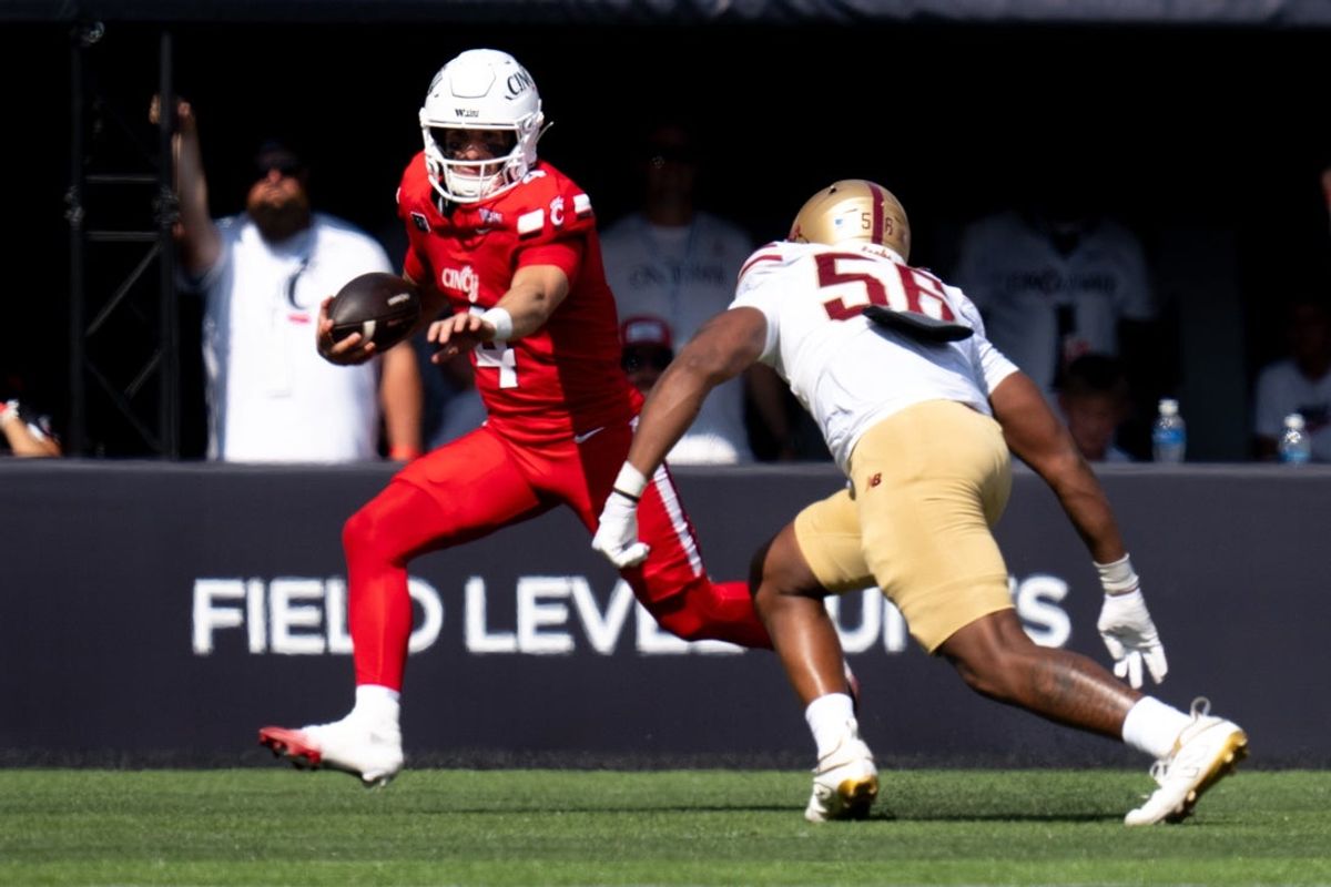 Cincinnati Bearcats quarterback JC French IV (4) runs the ball as Boston College Eagles defensive lineman E'Lla Boykin (56) defends in the first quarter of the football game between East Central High School and Elder High School in West Price Hill on Friday, September 4, 2026.
