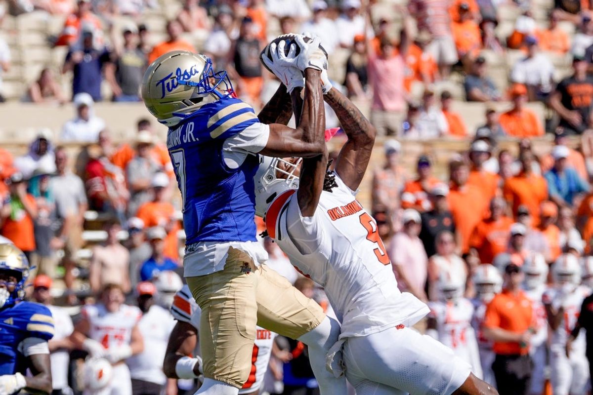 Tulsa wide receiver Jimmy Calloway (7) catches a pass over Oklahoma State cornerback LaDainian Fields (9) during the first half of a college football game between Oklahoma State (OSU) and Tulsa at  H. A. Chapman Stadium in Tulsa, Okla., on Saturday, Sept. 5, 2026.