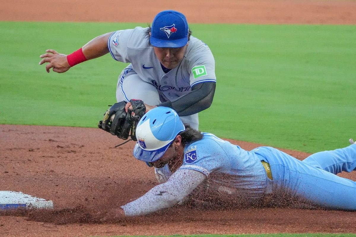 Sep 5, 2026; Kansas City, Missouri, USA; Kansas City Royals right fielder Jac Caglianone (14) is tagged out by Toronto Blue Jays third baseman Kazuma Okamoto (7) trying to get back to third base during the first inning at Kauffman Stadium. Mandatory Credit: Denny Medley-Imagn Images