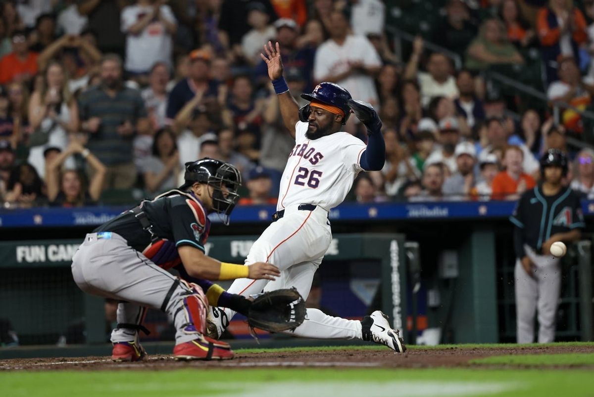 Sep 5, 2026; Houston, Texas, USA;  Houston Astros left fielder Taylor Trammell (26) slides home safely against Arizona Diamondbacks catcher Gabriel Moreno (14) in the third inning at Daikin Park.  Mandatory Credit: Thomas Shea-Imagn Images
