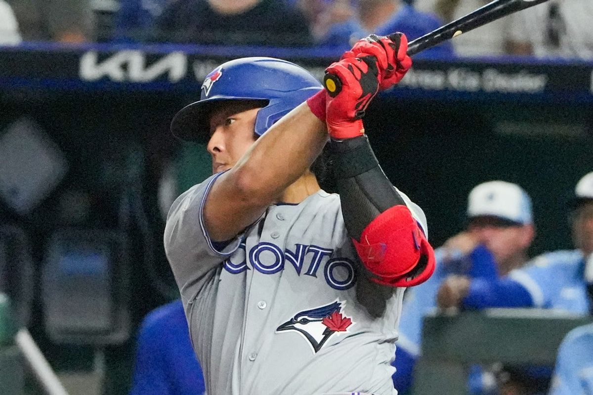 Sep 5, 2026; Kansas City, Missouri, USA; Toronto Blue Jays third baseman Kazuma Okamoto (7) hits a one-run single against the Kansas City Royals during the seventh inning at Kauffman Stadium. Mandatory Credit: Denny Medley-Imagn Images