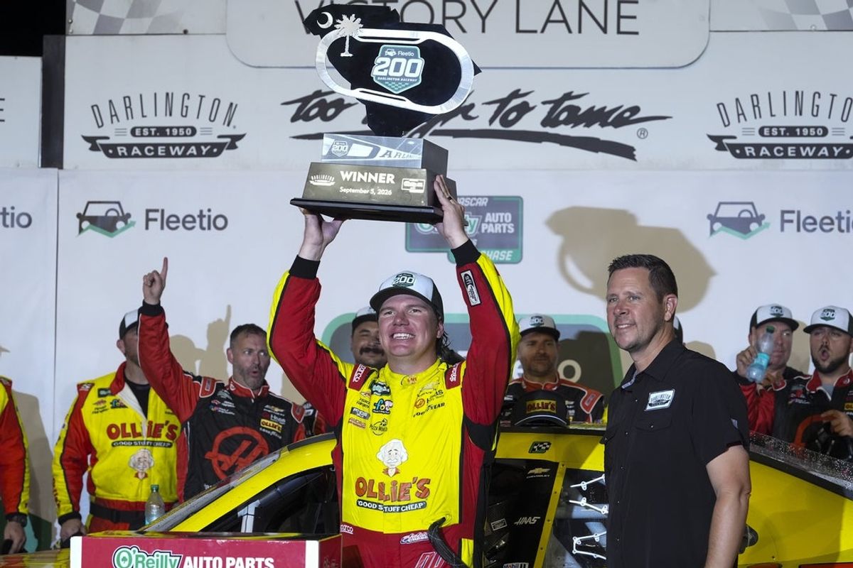 Sep 5, 2026; Darlington, South Carolina, USA;  Haas Factory Team driver Sheldon Creed (00) holds up the trophy winning the Fleetio 200 at Darlington Raceway.  Mandatory Credit: Jim Dedmon-Imagn Images