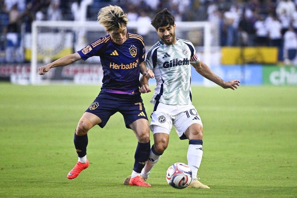 Sep 5, 2026; Carson, California, USA; LA Galaxy forward Kyogo Furuhashi (7) fouls New England Revolution midfielder Carles Gil (10) during the first half at Dignity Health Sports Park. Mandatory Credit: Kelvin Kuo-Imagn Images