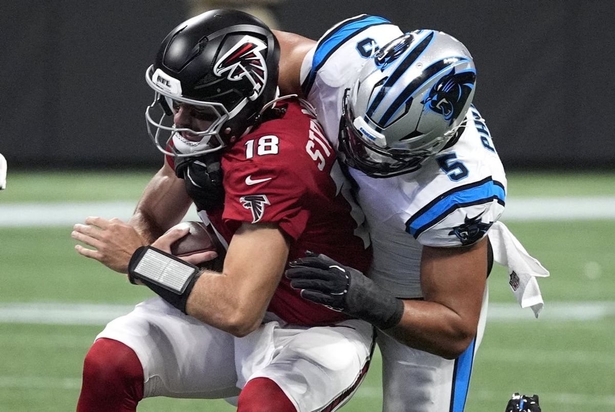 Atlanta Falcons quarterback Jack Strand (18) is sacked by Carolina Panthers linebacker Jaelan Phillips (5) during the third quarter at Mercedes-Benz Stadium.
