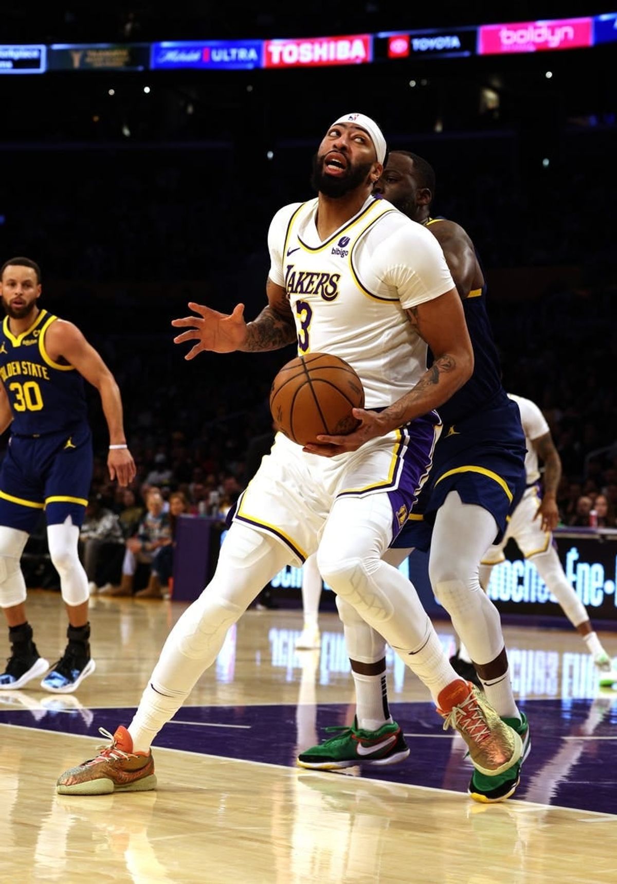 vMar 16, 2024; Los Angeles, California, USA; Los Angeles Lakers forward Anthony Davis (3) spins against Golden State Warriors forward Draymond Green (23) during the first quarter at Crypto.com Arena.
