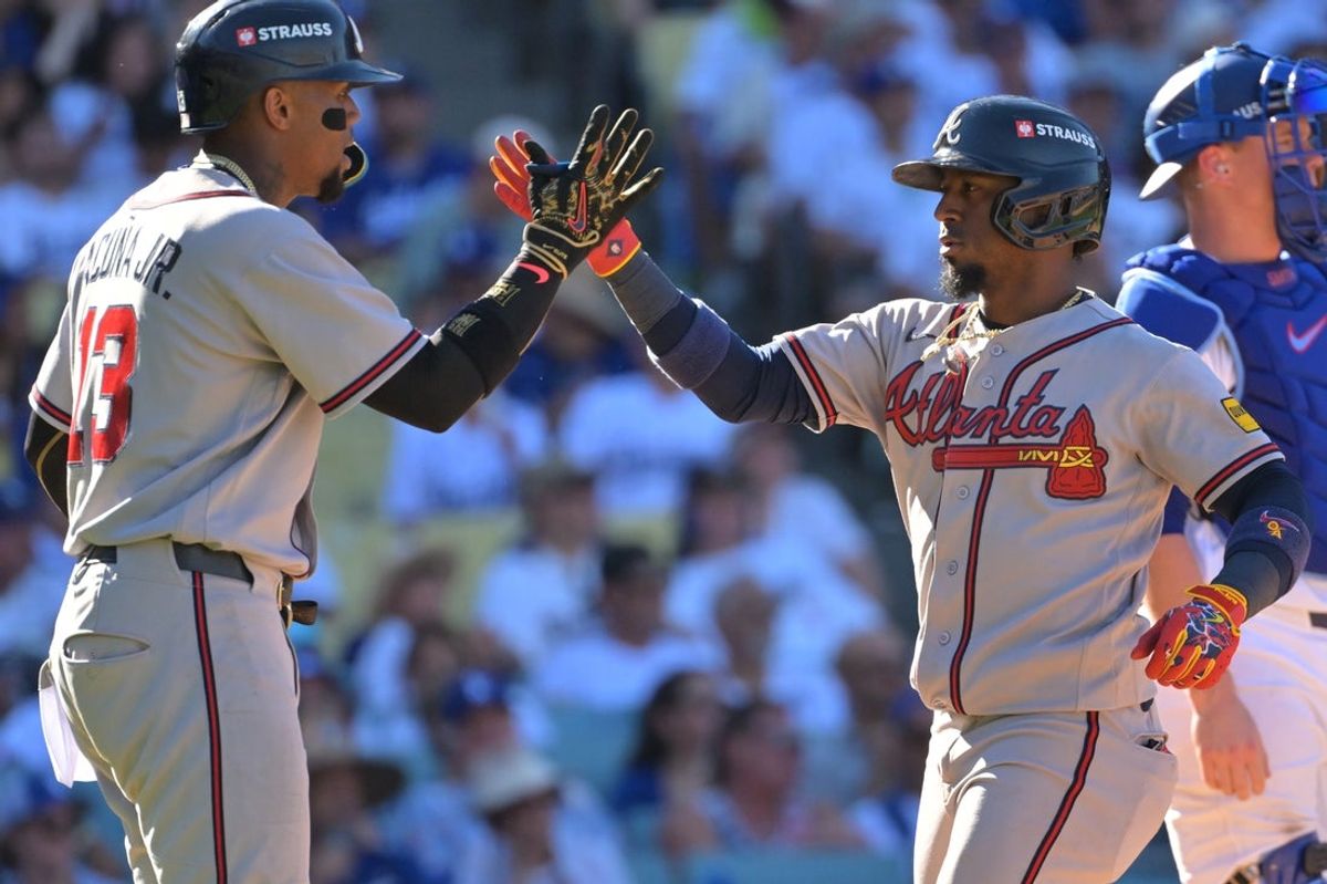 Oct 3, 2026; Los Angeles, California, USA;  Atlanta Braves outfielder Ronald Acuna Jr. (13) and second baseman Ozzie Albies (1) react after Albies hit a two run home run in the ninth inning of game one of the NLDS against the Los Angeles Dodgers for the 2026 MLB Playoffs at Uniqlo Field at Dodger Stadium.  Mandatory Credit: Jayne Kamin-Oncea-Imagn Images