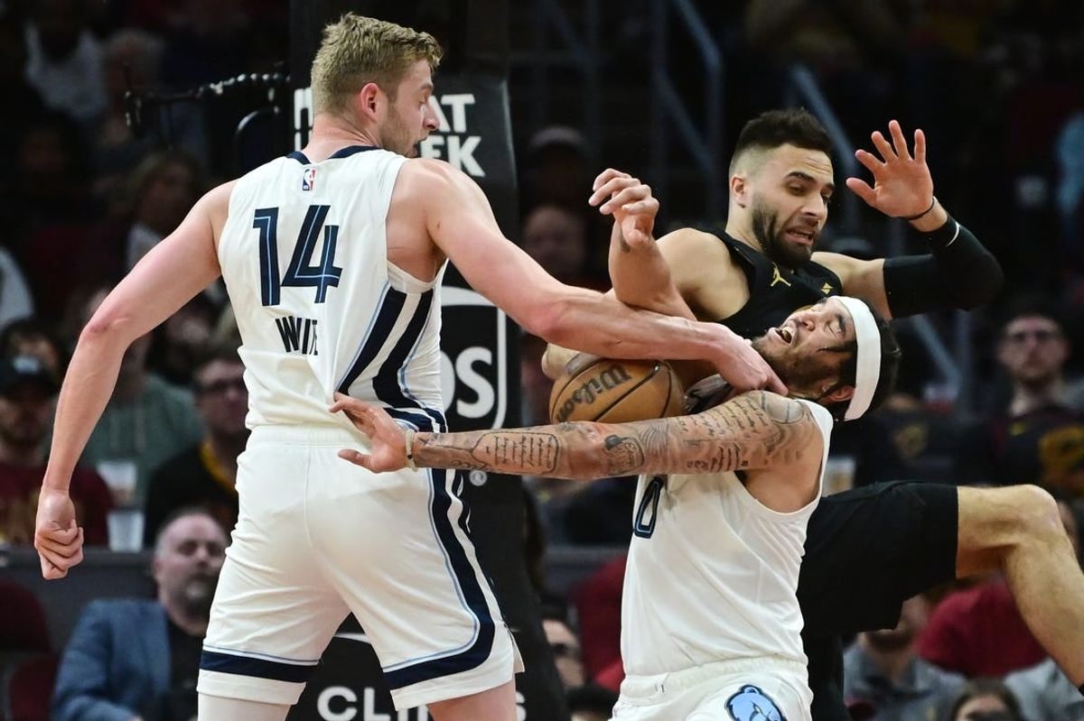 Apr 10, 2024; Cleveland, Ohio, USA; Memphis Grizzlies forward Jack White (14) and forward Timmy Allen (0) go for a rebound against Cleveland Cavaliers guard Max Strus (1) during the first half at Rocket Mortgage FieldHouse.