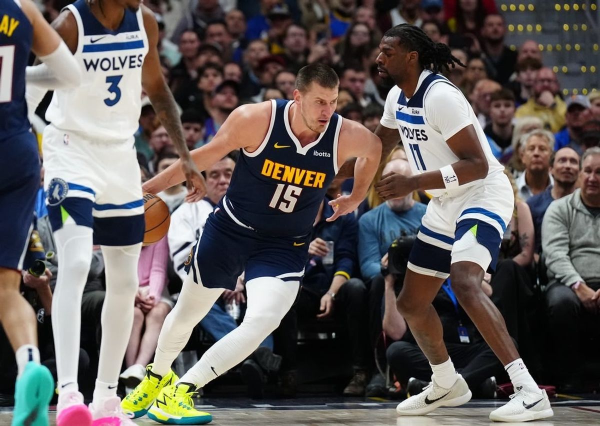 Apr 10, 2024; Denver, Colorado, USA; Minnesota Timberwolves center Naz Reid (11) defends Denver Nuggets center Nikola Jokic (15) in the first quarter at Ball Arena.