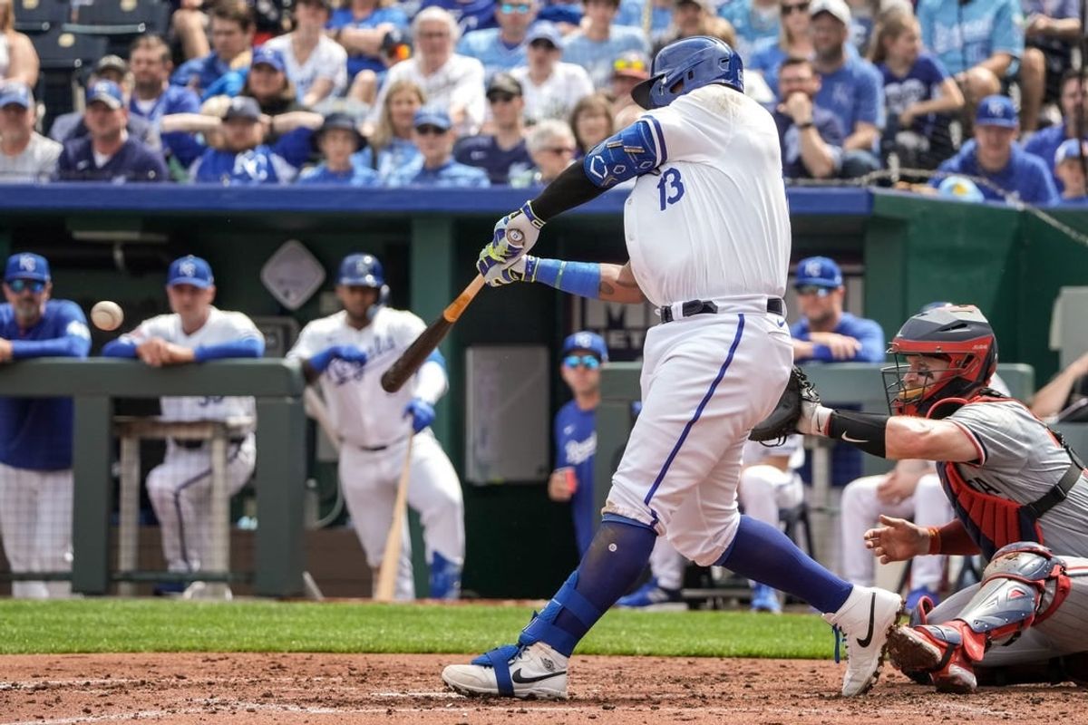 Mar 31, 2024; Kansas City, Missouri, USA; Kansas City Royals first baseman Salvador Perez (13) hits a one RBI single against the Minnesota Twins in the second inning at Kauffman Stadium.