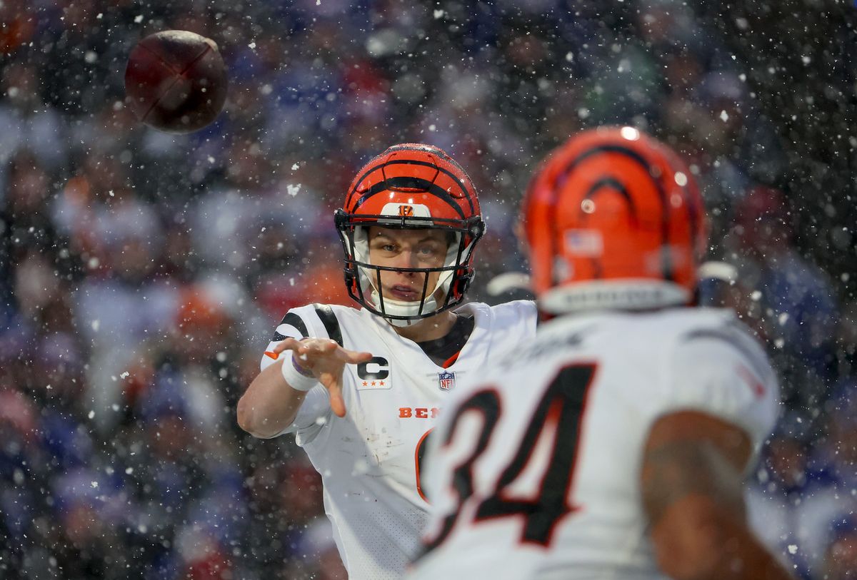 Joe Burrow tosses the ball to Samaje Perine during the second quarter in the AFC Divisional Playoff game on January 22, 2023.