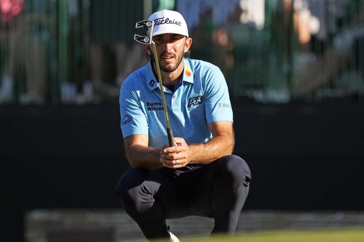 Apr 14, 2024; Augusta, Georgia, USA; Max Homa lines up his putt on the 15th green during the final round of the Masters Tournament.