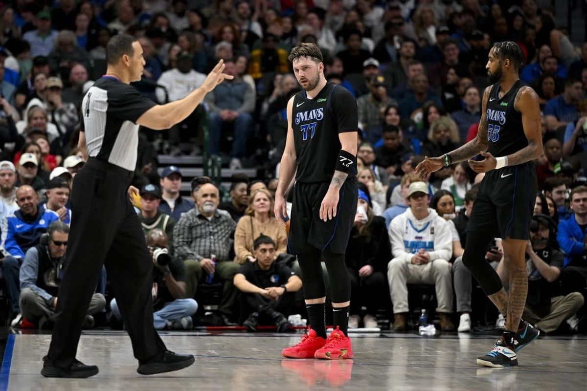 Feb 3, 2024; Dallas, Texas, USA; Dallas Mavericks guard Luka Doncic (77) reacts to being called for a foul by referee Curtis Blair (74) during the second quarter against the Milwaukee Bucks at the American Airlines Center.