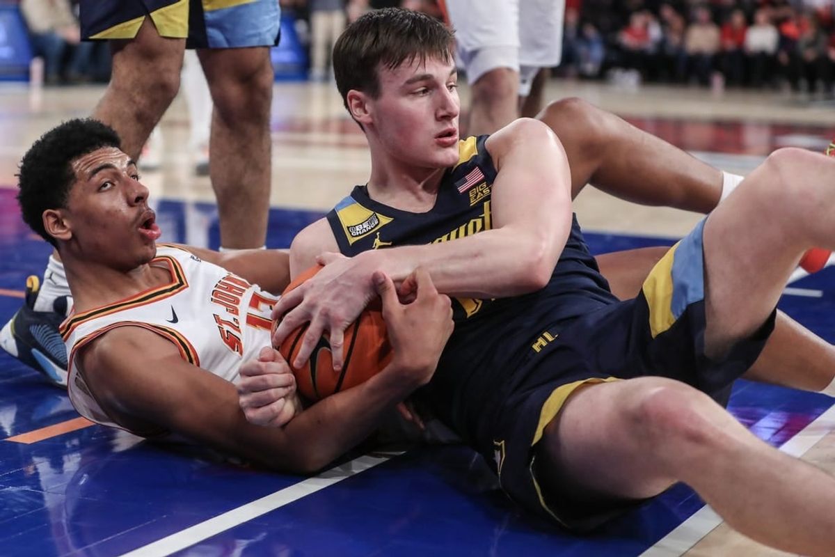 Jan 20, 2024; New York, New York, USA;  St. John's Red Storm guard RJ Luis Jr. (12) and Marquette Golden Eagles guard Tyler Kolek (11) fight for a loose ball in the second half at Madison Square Garden.