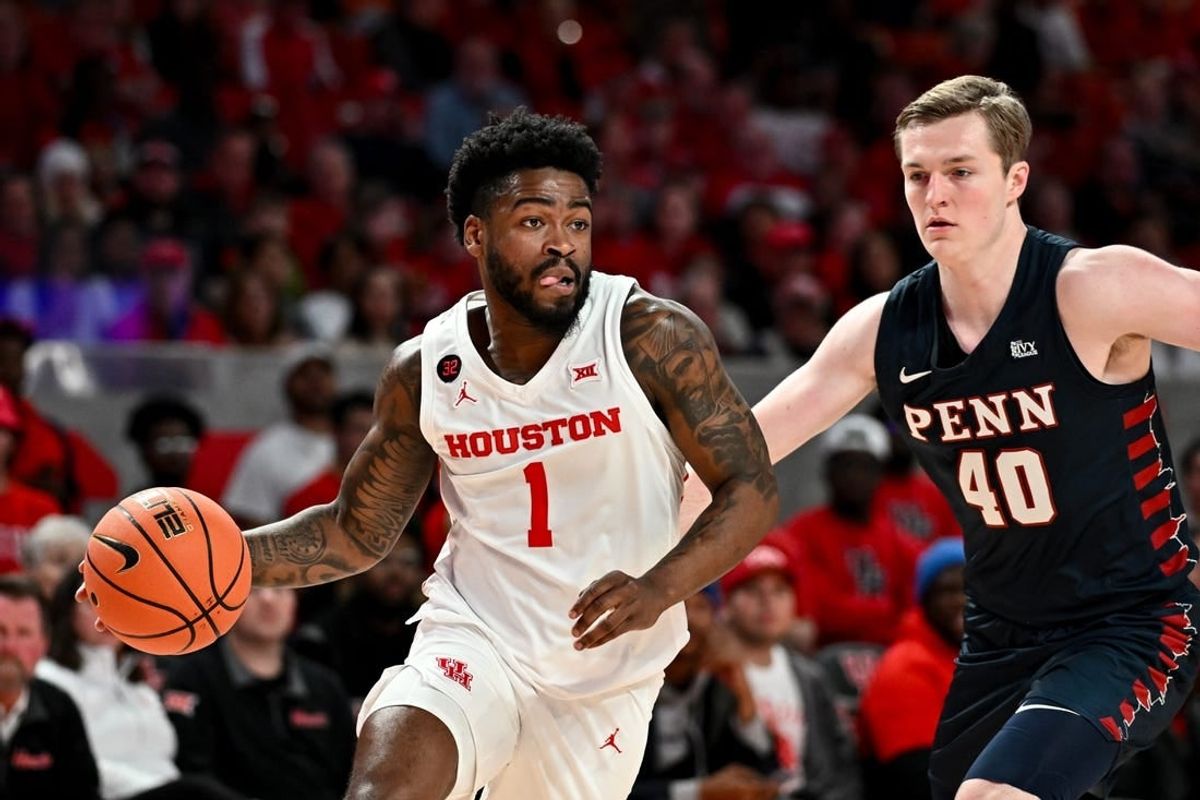 Dec 30, 2023; Houston, Texas, USA;  Houston Cougars guard Jamal Shead (1) controls the ball as Pennsylvania Quakers guard George Smith (40) defends during the first half at Fertitta Center.