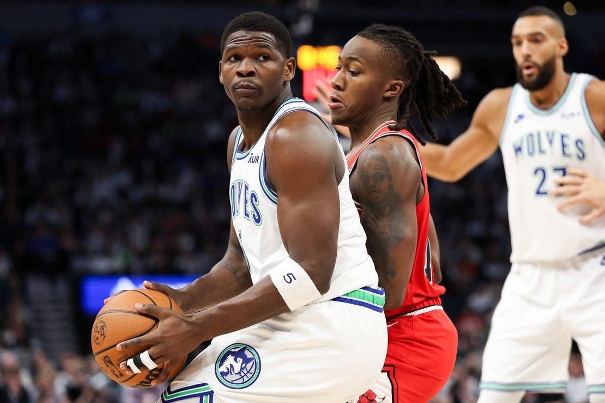 Mar 31, 2024; Minneapolis, Minnesota, USA; Minnesota Timberwolves guard Anthony Edwards (5) works around Chicago Bulls guard Ayo Dosunmu (12) during the first half at Target Center.