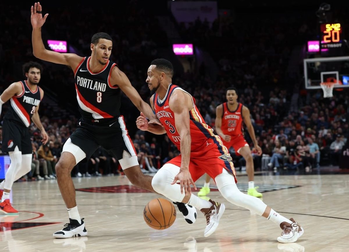 Apr 9, 2024; Portland, Oregon, USA; New Orleans Pelicans guard CJ McCollum (3) dribbles the ball against Portland Trail Blazers forward Kris Murray (8) in the second quarter at Moda Center.