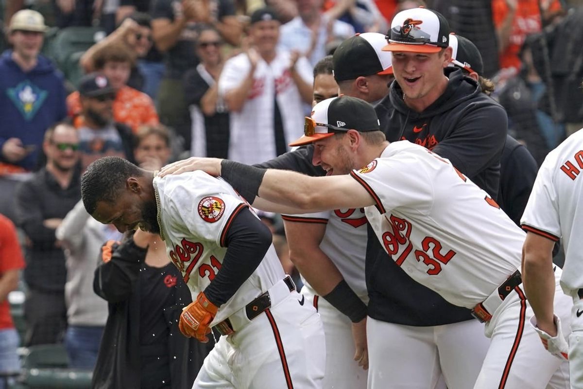 Apr 17, 2024; Baltimore, Maryland, USA; Baltimore Orioles outfielder Cedric Mullins (21) greeted by outfielder Ryan O’Hearn (32) following his game winning two run home run in the ninth inning against the Minnesota Twins at Oriole Park at Camden Yards.