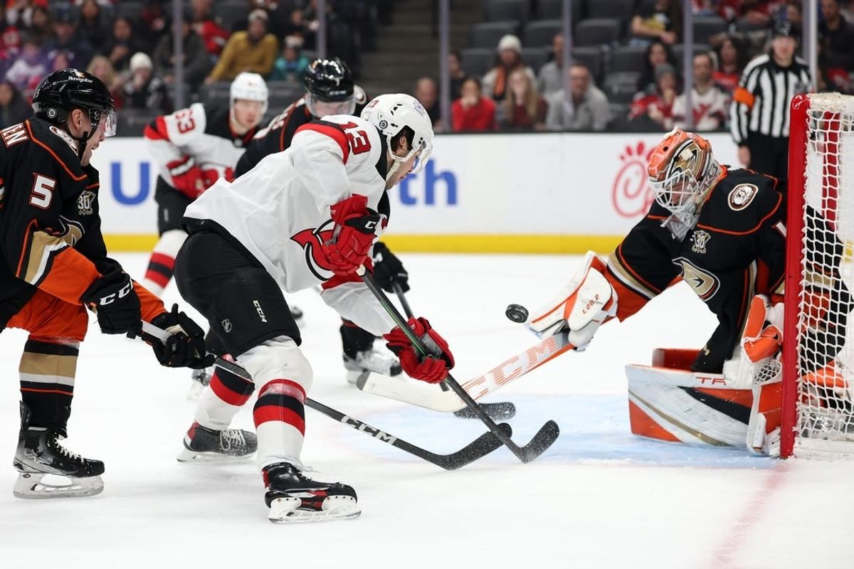 Mar 1, 2024; Anaheim, California, USA; New Jersey Devils center Nico Hischier (13) shoots the puck against Anaheim Ducks goaltender Lukas Dostal (1) during the first period at Honda Center.