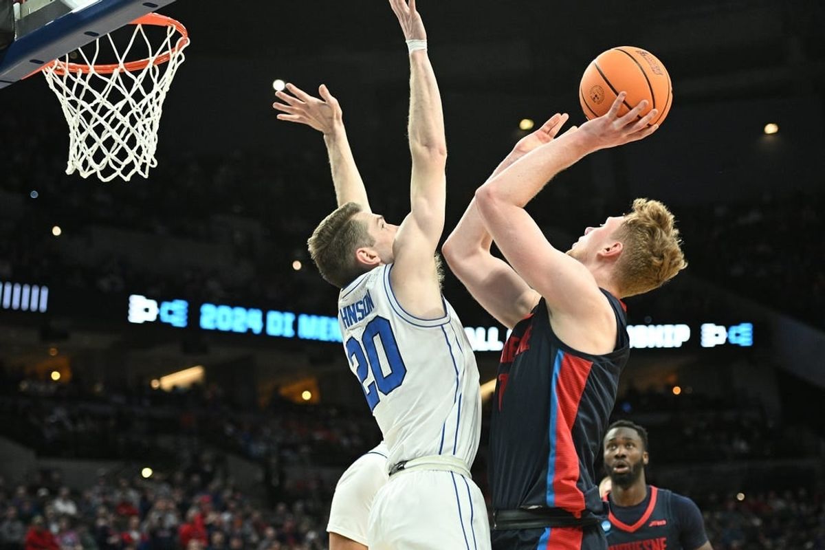 Mar 21, 2024; Omaha, NE, USA; Duquesne Dukes forward Jakub Necas (7) shoots against Brigham Young Cougars guard Spencer Johnson (20) in the first half during the first round of the NCAA Tournament at CHI Health Center Omaha.