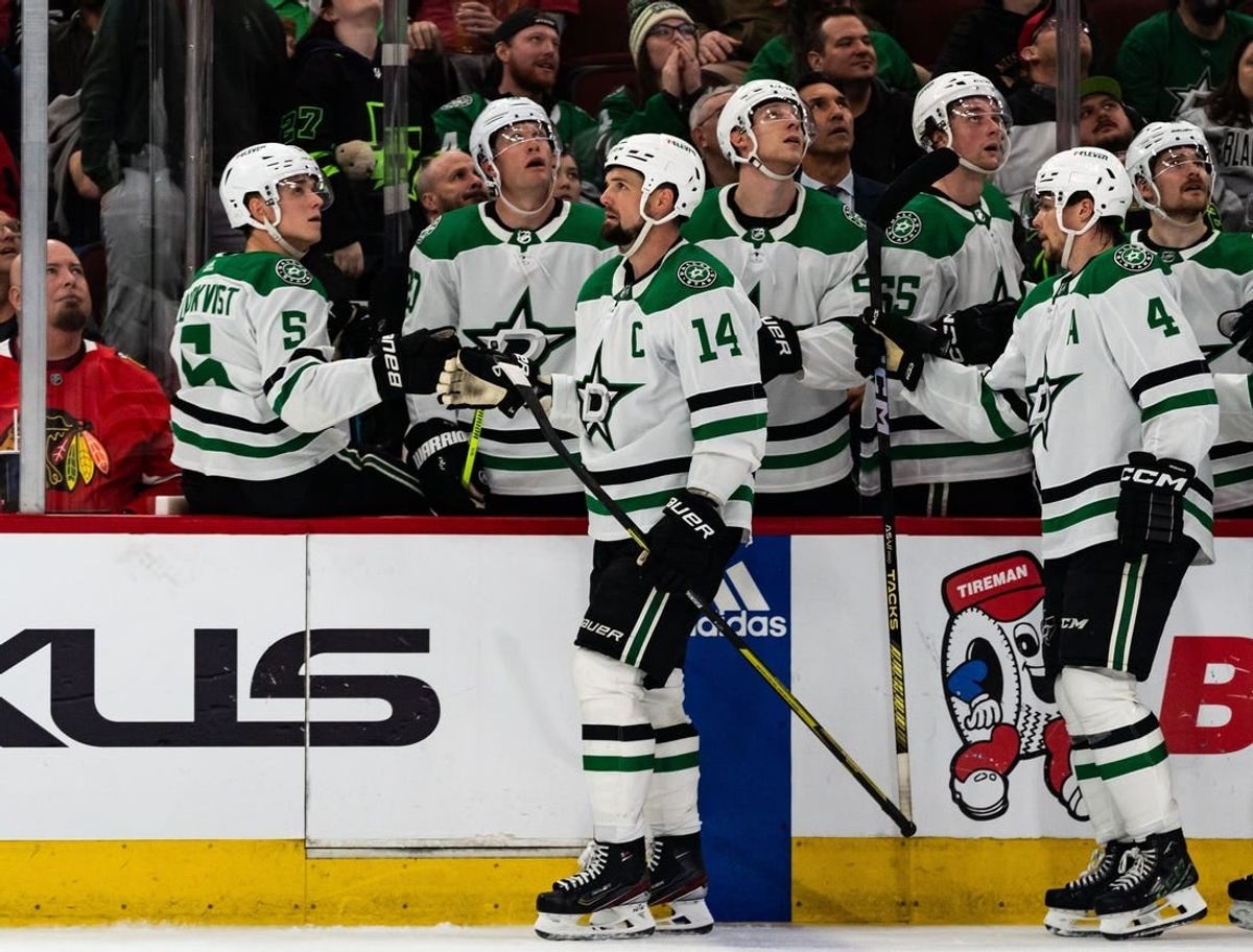 Apr 6, 2024; Chicago, Illinois, USA; Dallas Stars left winger Jamie Benn (14) high-fives teammates while waiting for referees to review his successful goal against the Chicago Blackhawks during the third period at United Center.