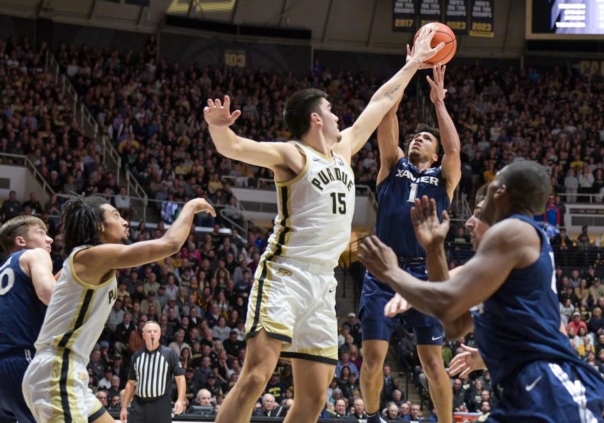 Nov 13, 2023; West Lafayette, Indiana, USA; Purdue Boilermakers center Zach Edey (15) blocks a shot by Xavier Musketeers guard Desmond Claude (1) during the first half at Mackey Arena.
