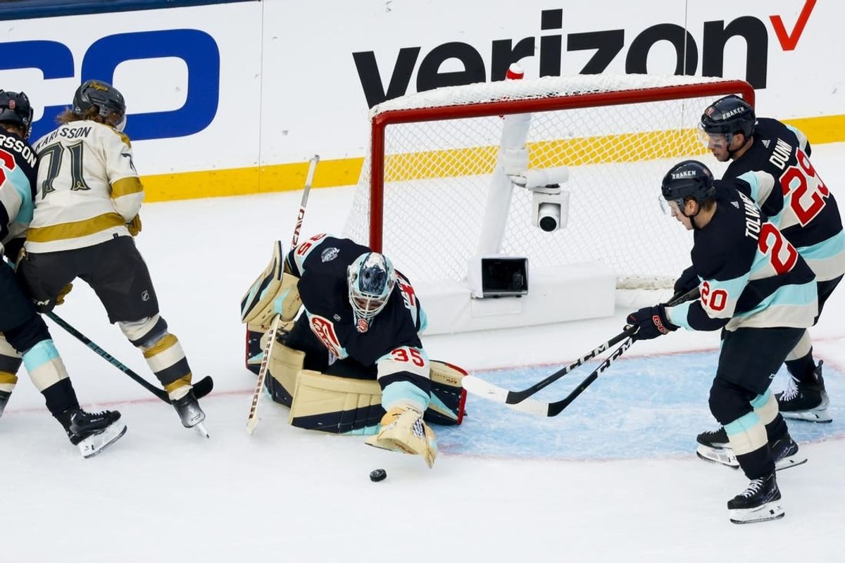 Jan 1, 2024; Seattle, Washington, USA; Seattle Kraken goaltender Joey Daccord (35) makes a save against the Vegas Golden Knights during the second period in the 2024 Winter Classic ice hockey game at T-Mobile Park.