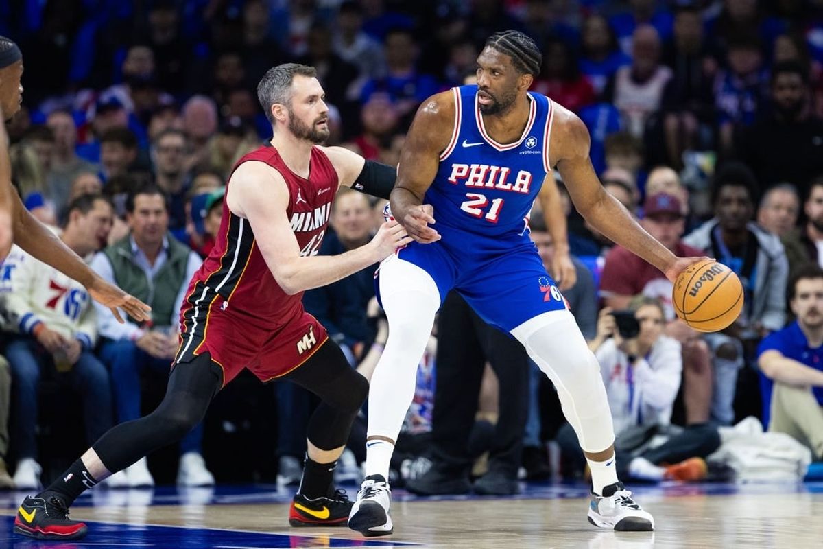 Apr 17, 2024; Philadelphia, Pennsylvania, USA; Philadelphia 76ers center Joel Embiid (21) controls the ball against Miami Heat forward Kevin Love (42) during the first quarter of a play-in game of the 2024 NBA playoffs at Wells Fargo Center.