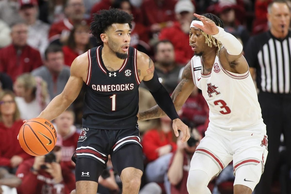 Jan 20, 2024; Fayetteville, Arkansas, USA; South Carolina Gamecocks guard Jacobi Wright (1) drives against Arkansas Razorbacks guard El Ellis (3) during the first half at Bud Walton Arena.