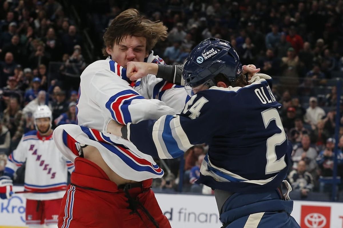 Feb 25, 2024; Columbus, Ohio, USA; Columbus Blue Jackets right wing Mathieu Olivier (24) and New York Rangers center Matt Rempe (73) fight during the first period at Nationwide Arena.